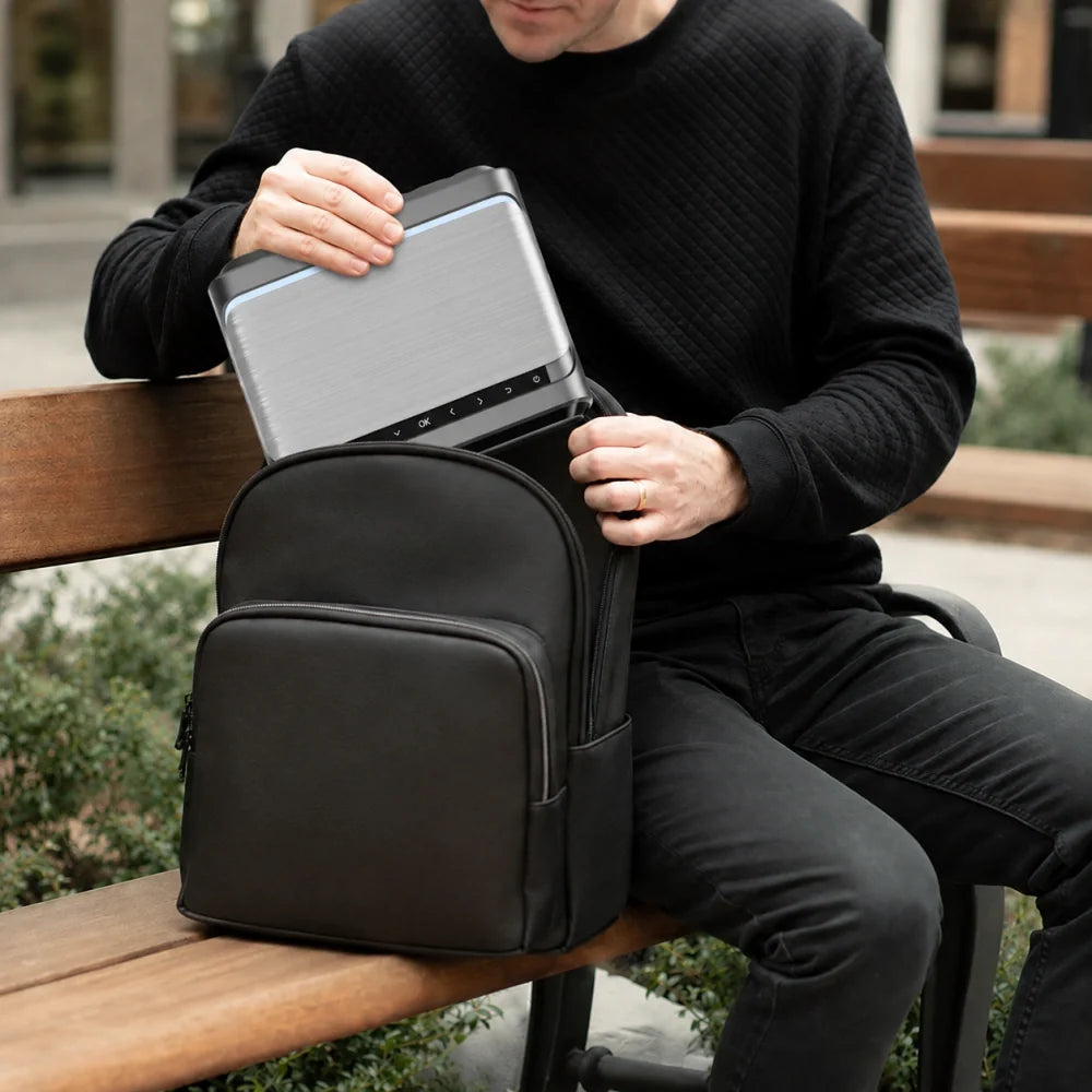 Small handheld portable mini projector easily putting in a should bag, showing compact size and lightweight build